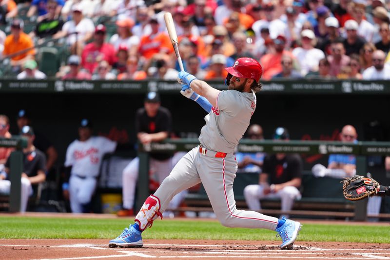 Jun 16, 2024; Baltimore, Maryland, USA; Philadelphia Phillies first baseman Bryce Harper (3) hits a single against the Baltimore Orioles during the first inning at Oriole Park at Camden Yards. Mandatory Credit: Gregory Fisher-USA TODAY Sports