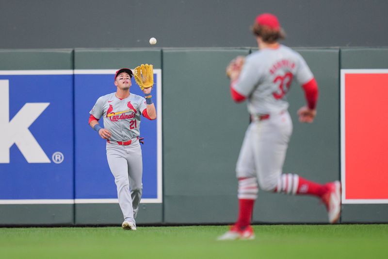 Aug 23, 2024; Minneapolis, Minnesota, USA; St. Louis Cardinals outfielder Lars Nootbaar (21) fields a fly ball against the Minnesota Twins in the second inning at Target Field. Mandatory Credit: Brad Rempel-USA TODAY Sports