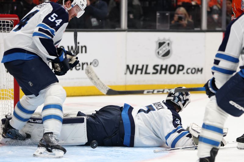 Feb 27, 2026; Anaheim, California, USA;  Winnipeg Jets defenseman Dylan Samberg (54) reacts to the puck during the third period against the Anaheim Ducks at Honda Center. Mandatory Credit: Kiyoshi Mio-Imagn Images