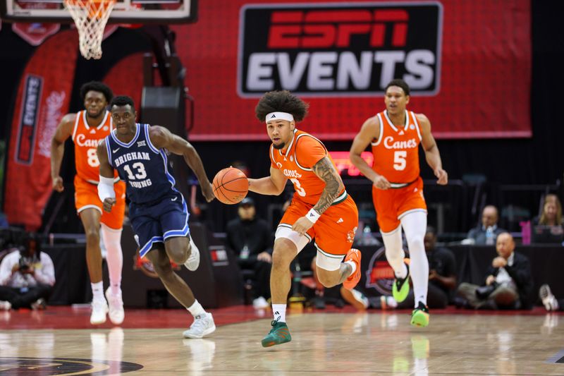 Nov 27, 2025; Kissimmee, Florida, USA; Miami (FL) Hurricanes guard Tre Donaldson (3) controls the ball against the Brigham Young University Cougars in the first half at State Farm Field House. Mandatory Credit: Nathan Ray Seebeck-Imagn Images