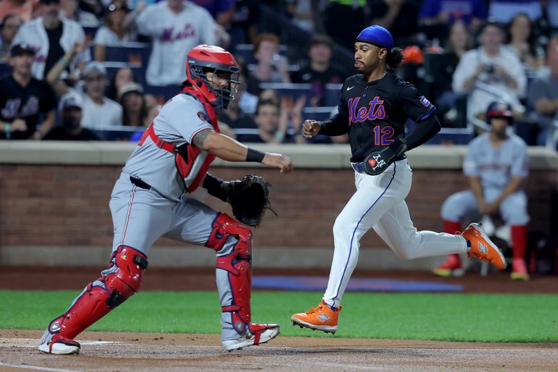 Sep 19, 2025; New York City, New York, USA; New York Mets shortstop Francisco Lindor (12) scores against Washington Nationals catcher Jorge Alfaro (44) after an error by Nationals right fielder Dylan Crews (not pictured) on a single by Mets first baseman Pete Alonso (not pictured) during the first inning at Citi Field. Mandatory Credit: Brad Penner-Imagn Images