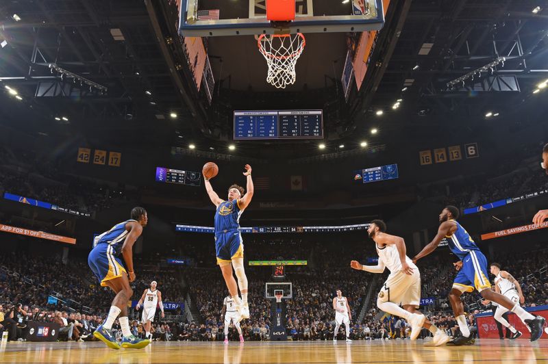 SAN FRANCISCO, CA - JANUARY 4: Brandin Podziemski #2 of the Golden State Warriors rebounds the ball during the game against the Denver Nuggets on January 4, 2024 at Chase Center in San Francisco, California. NOTE TO USER: User expressly acknowledges and agrees that, by downloading and or using this photograph, user is consenting to the terms and conditions of Getty Images License Agreement. Mandatory Copyright Notice: Copyright 2024 NBAE (Photo by Noah Graham/NBAE via Getty Images)