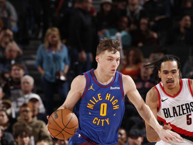 PORTLAND, OR - FEBRUARY 23: Christian Braun #0 of the Denver Nuggets dribbles the ball during the game against the Portland Trail Blazers on February 23, 2024 at the Moda Center Arena in Portland, Oregon. NOTE TO USER: User expressly acknowledges and agrees that, by downloading and or using this photograph, user is consenting to the terms and conditions of the Getty Images License Agreement. Mandatory Copyright Notice: Copyright 2024 NBAE (Photo by Cameron Browne/NBAE via Getty Images)