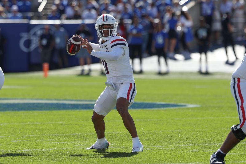 Oct 12, 2024; Provo, Utah, USA; Arizona Wildcats quarterback Noah Fifita (11) passes the ball against the Brigham Young Cougars during the first quarter at LaVell Edwards Stadium. Mandatory Credit: Rob Gray-Imagn Images