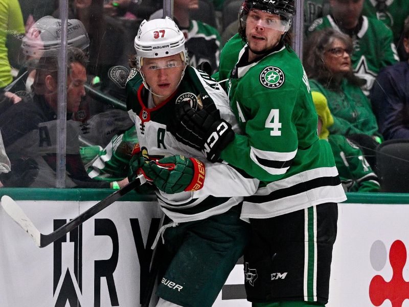 Oct 14, 2025; Dallas, Texas, USA; Dallas Stars defenseman Miro Heiskanen (4) checks Minnesota Wild left wing Kirill Kaprizov (97) during the first period at the American Airlines Center. Mandatory Credit: Jerome Miron-Imagn Images