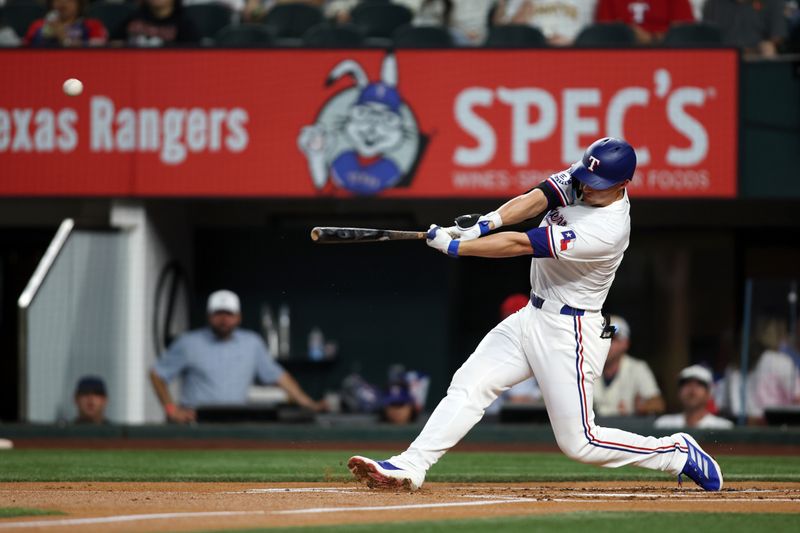 Aug 19, 2024; Arlington, Texas, USA; Texas Rangers shortstop Corey Seager (5) hits a home run against the Pittsburgh Pirates in the first inning at Globe Life Field. Mandatory Credit: Tim Heitman-USA TODAY Sports