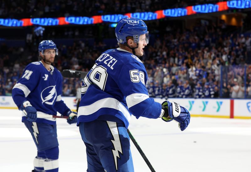 Nov 14, 2024; Tampa, Florida, USA; Tampa Bay Lightning center Jake Guentzel (59) is congratulated  after he scored  goal against the Winnipeg Jets during the third period at Amalie Arena. Mandatory Credit: Kim Klement Neitzel-Imagn Images