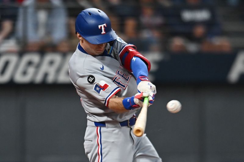 Sep 27, 2025; Cleveland, Ohio, USA; Texas Rangers center fielder Michael Helman (24) hits a double against the Cleveland Guardians during the first inning at Progressive Field. Mandatory Credit: Ken Blaze-Imagn Images