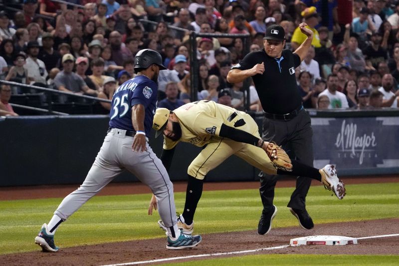 Jul 28, 2023; Phoenix, Arizona, USA; Seattle Mariners right fielder Teoscar Hernandez (35) beats the tag of Arizona Diamondbacks third baseman Emmanuel Rivera (15) at third base during the first inning at Chase Field. Mandatory Credit: Joe Camporeale-USA TODAY Sports