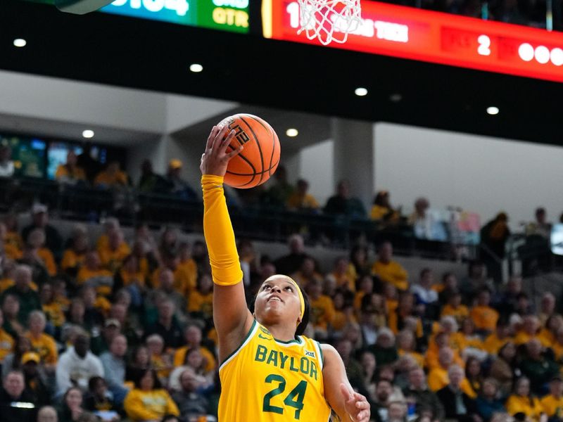 Feb 18, 2024; Waco, Texas, USA; Baylor Lady Bears guard Sarah Andrews (24) scores a layup past Texas Tech Red Raiders guard Bailey Maupin (20)  during the second half at Paul and Alejandra Foster Pavilion. Mandatory Credit: Chris Jones-USA TODAY Sports