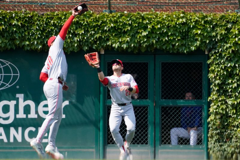 Jun 1, 2025; Chicago, Illinois, USA; Cincinnati Reds outfielder Will Benson (30) makes an error on a ball hit by Chicago Cubs outfielder Pete Crow-Armstrong (not pictured) during the seventh inning at Wrigley Field. Mandatory Credit: David Banks-Imagn Images
