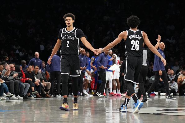 BROOKLYN, NY - DECEMBER 23: Cameron Johnson #2 high fives Spencer Dinwiddie #26 of the Brooklyn Nets during the game against the Detroit Pistons on December 23, 2023 at Barclays Center in Brooklyn, New York. NOTE TO USER: User expressly acknowledges and agrees that, by downloading and or using this Photograph, user is consenting to the terms and conditions of the Getty Images License Agreement. Mandatory Copyright Notice: Copyright 2023 NBAE (Photo by Jesse D. Garrabrant/NBAE via Getty Images)