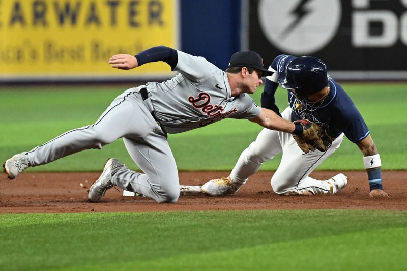 Apr 23, 2024; St. Petersburg, Florida, USA; Detroit Tigers second baseman Colt Keith (33) attempts to tag out Tampa Bay Rays designated hitter Harold Ramirez (43) in the second inning at Tropicana Field. Mandatory Credit: Jonathan Dyer-USA TODAY Sports