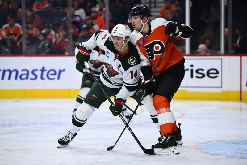 Oct 26, 2024; Philadelphia, Pennsylvania, USA; Minnesota Wild center Joel Eriksson Ek (14) and Philadelphia Flyers defenseman Rasmus Ristolainen (55) battle for position in the second period at Wells Fargo Center. Mandatory Credit: Kyle Ross-Imagn Images