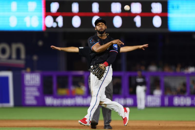 Jul 19, 2024; Miami, Florida, USA; Miami Marlins second baseman Otto Lopez (61) throws to first base but cannot retire New York Mets right fielder Jeff McNeil (not pictured) during the eighth inning at loanDepot Park. Mandatory Credit: Sam Navarro-USA TODAY Sports