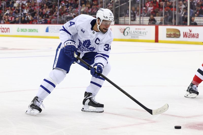 Oct 10, 2024; Newark, New Jersey, USA; Toronto Maple Leafs center Auston Matthews (34) skates with the puck against the New Jersey Devils during the first period at Prudential Center. Mandatory Credit: Ed Mulholland-Imagn Images