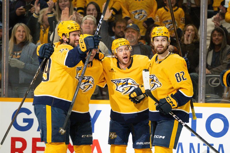 Nov 23, 2024; Nashville, Tennessee, USA;  Nashville Predators center Tommy Novak (82) celebrates his goal with his teammates  against the Winnipeg Jets during the third period at Bridgestone Arena. Mandatory Credit: Steve Roberts-Imagn Images
