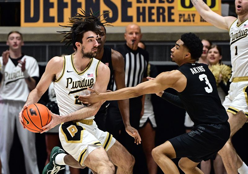 Mar 2, 2024; West Lafayette, Indiana, USA; Purdue Boilermakers guard Ethan Morton (25) looks to get the ball past Michigan State Spartans guard Jaden Akins (3) during the first half at Mackey Arena. Mandatory Credit: Marc Lebryk-USA TODAY Sports