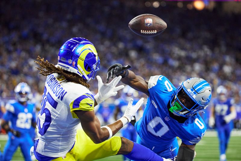 Detroit Lions cornerback Terrion Arnold (0) is called for interference on Los Angeles Rams wide receiver Demarcus Robinson (15) in the second half of an NFL football game in Detroit, Sunday, Sept. 8, 2024. (AP Photo/Rick Osentoski)