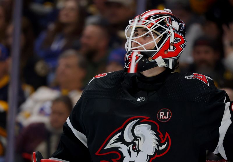 Dec 27, 2023; Buffalo, New York, USA;  Buffalo Sabres goaltender Devon Levi (27) looks to the scoreboard during the third period against the Boston Bruins at KeyBank Center. Mandatory Credit: Timothy T. Ludwig-USA TODAY Sports