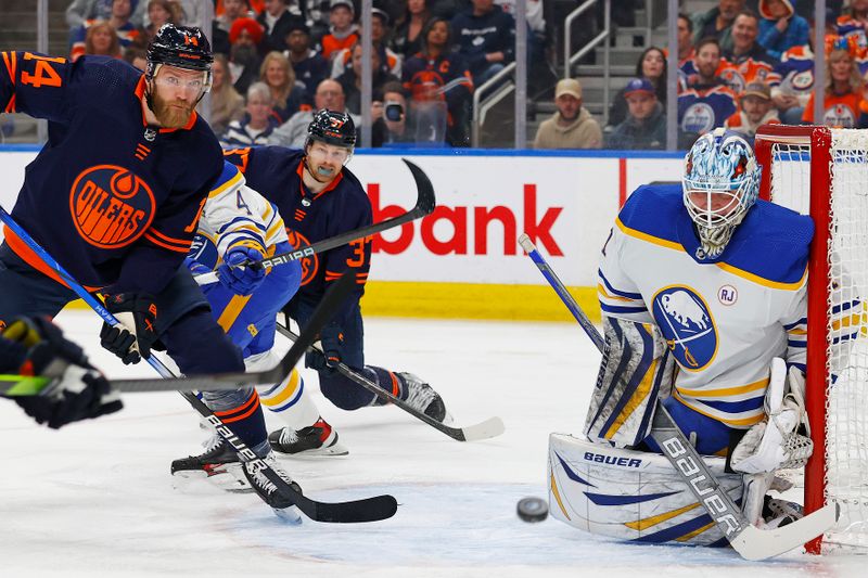 Mar 21, 2024; Edmonton, Alberta, CAN; Edmonton Oilers defensemen Mattias Ekholm (14) looks for a loose puck in front of Buffalo Sabres goaltender Ukko-Pekka Luukkonen (1) during the first period at Rogers Place. Mandatory Credit: Perry Nelson-USA TODAY Sports