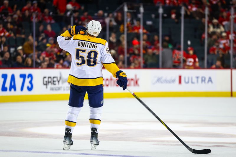 Jan 3, 2026; Calgary, Alberta, CAN; Nashville Predators left wing Michael Bunting (58) celebrates goal by Nashville Predators defenseman Nicolas Hague (not pictured) during the third period against the Calgary Flames at Scotiabank Saddledome. Mandatory Credit: Sergei Belski-Imagn Images