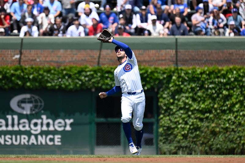 May 31, 2025; Chicago, Illinois, USA;  Chicago Cubs shortstop Dansby Swanson (7) catches a fly ball hit by Cincinnati Reds outfielder TJ Friedl (29) during the first inning at Wrigley Field. Mandatory Credit: Matt Marton-Imagn Images