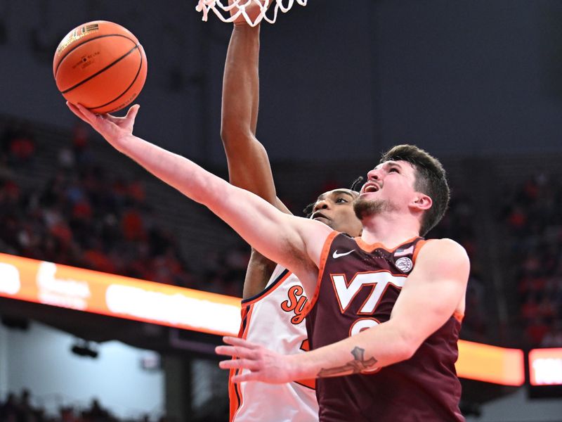 Feb 27, 2024; Syracuse, New York, USA; Virginia Tech Hokies guard Hunter Cattoor (0) takes a shot against Syracuse Orange guard JJ Starling (2) in the first half at the JMA Wireless Dome. Mandatory Credit: Mark Konezny-USA TODAY Sports