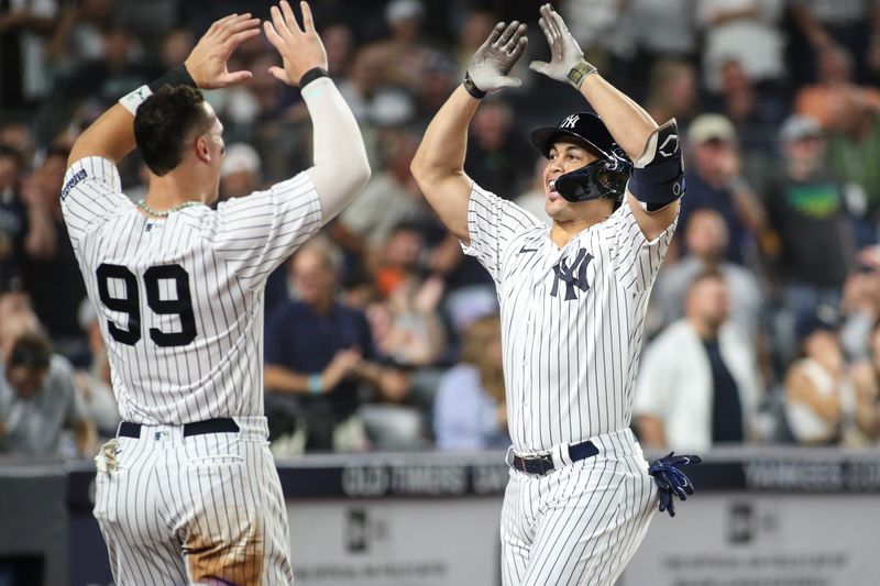 Sep 5, 2023; Bronx, New York, USA;  New York Yankees designated hitter Giancarlo Stanton (27) is greeted by right fielder Aaron Judge (99) after hitting a two run home run in the sixth inning for his 400th career home run against the Detroit Tigers at Yankee Stadium. Mandatory Credit: Wendell Cruz-USA TODAY Sports