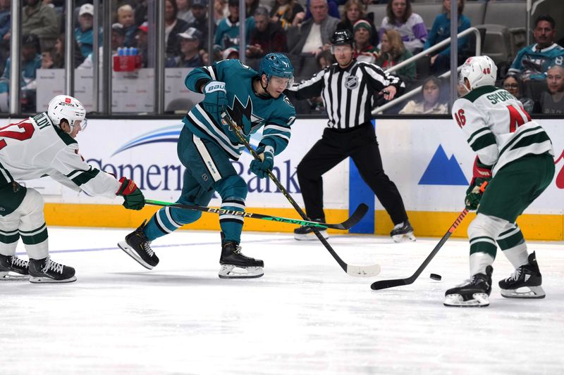 Mar 11, 2023; San Jose, California, USA; San Jose Sharks defenseman Nikolai Knyzhov (71) shoots the puck against Minnesota Wild defenseman Jared Spurgeon (46) and left wing Matt Boldy (12) during the second period at SAP Center at San Jose. Mandatory Credit: Darren Yamashita-USA TODAY Sports