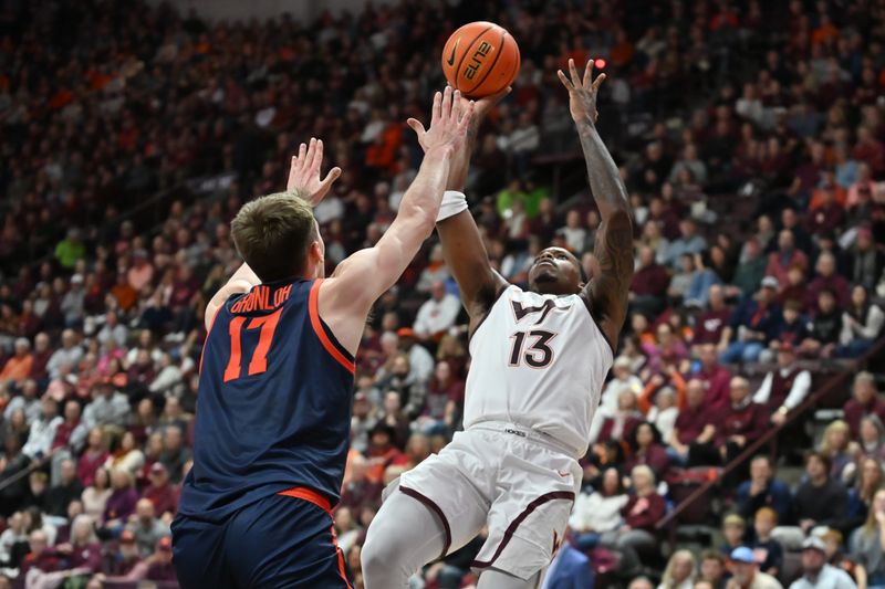 Dec 31, 2025; Blacksburg, Virginia, USA;   Virginia Tech Hokies forward Amani Hansberry (13) shoots a shot as Virginia Cavaliers center Johann Grünloh (17) defends during the first half at Cassell Coliseum. Mandatory Credit: Brian Bishop-Imagn Images