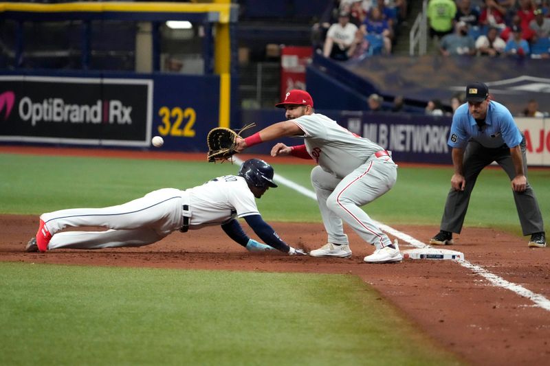 Jul 4, 2023; St. Petersburg, Florida, USA; Tampa Bay Rays shortstop Wander Franco (5) dives back to first safely as Philadelphia Phillies first baseman Darick Hall (24) tries to make the tag at Tropicana Field. Mandatory Credit: Dave Nelson-USA TODAY Sports