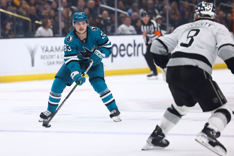 Dec 27, 2023; Los Angeles, California, USA; San Jose Sharks defenseman Calen Addison (33) skates with the puck against the Los Angeles Kings during the first period of a game at Crypto.com Arena. Mandatory Credit: Jessica Alcheh-USA TODAY Sports