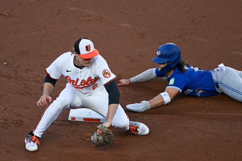 May 13, 2024; Baltimore, Maryland, USA; Toronto Blue Jays shortstop Bo Bichette (11) slides into second base before Baltimore Orioles shortstop Gunnar Henderson (2) can apply a tag on a second inning steal attempt at Oriole Park at Camden Yards. Mandatory Credit: Tommy Gilligan-USA TODAY Sports