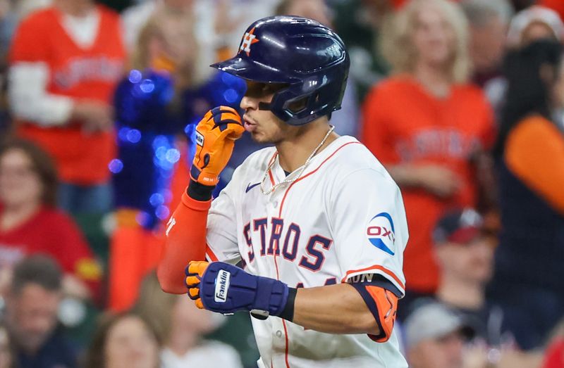 Apr 17, 2024; Houston, Texas, USA; Houston Astros center fielder Mauricio Dubon (14) reacts after hitting a home run against the Atlanta Braves in the sixth inning at Minute Maid Park. Mandatory Credit: Thomas Shea-USA TODAY Sports