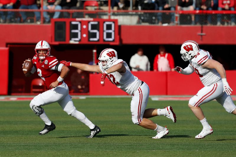 Nov 16, 2019; Lincoln, NE, USA; Nebraska Cornhuskers quarterback Adrian Martinez (2) runs against Wisconsin Badgers defensive end Matt Henningsen (92) in the second half at Memorial Stadium. Mandatory Credit: Bruce Thorson-USA TODAY Sports