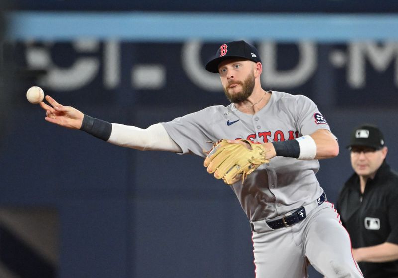 May 1, 2025; Toronto, Ontario, CAN;  Boston Red Sox shortstop Trevor Story (10) throws out Toronto Blue Jays catcher Alejandro Kirk (not shown) in the seventh inning at Rogers Centre. Mandatory Credit: Dan Hamilton-Imagn Images