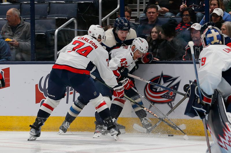 Dec 21, 2023; Columbus, Ohio, USA; Washington Capitals defenseman Martin Fehervary (42) checks Columbus Blue Jackets left wing Dmitri Voronkov (10) during the first period at Nationwide Arena. Mandatory Credit: Russell LaBounty-USA TODAY Sports