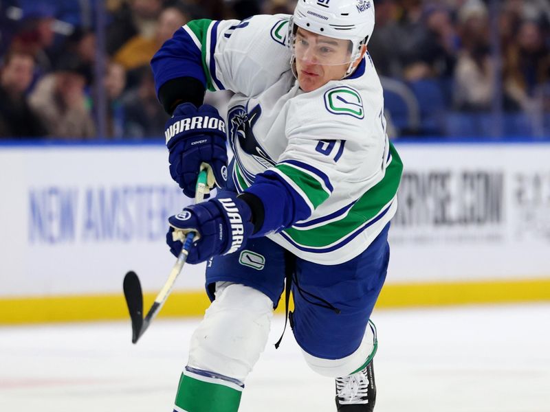 Jan 13, 2024; Buffalo, New York, USA;  Vancouver Canucks defenseman Nikita Zadorov (91) takes a shot on goal during the first period against the Buffalo Sabres at KeyBank Center. Mandatory Credit: Timothy T. Ludwig-USA TODAY Sports