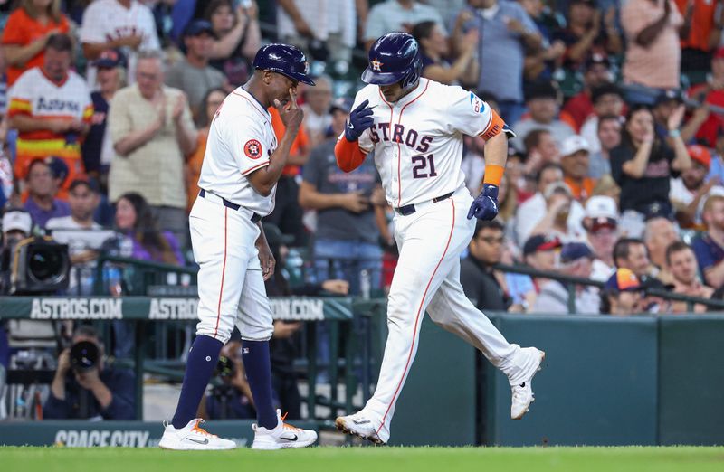 Jun 5, 2024; Houston, Texas, USA; Houston Astros designated hitter Yainer Diaz (21) celebrates with third base coach Gary Pettis (8) after hitting a home run during the fifth inning against the St. Louis Cardinals at Minute Maid Park. Mandatory Credit: Troy Taormina-USA TODAY Sports