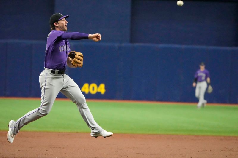 Aug 23, 2023; St. Petersburg, Florida, USA; Colorado Rockies third baseman Ryan McMahon (24) throws out Tampa Bay Rays first baseman Yandy Diaz (2) during the third inning at Tropicana Field. Mandatory Credit: Dave Nelson-USA TODAY Sports