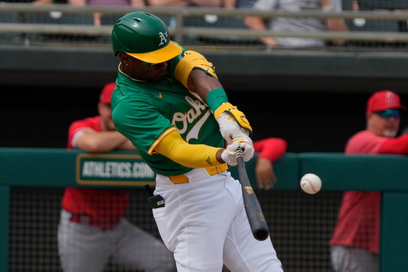 Mar 23, 2024; Mesa, Arizona, USA; Oakland Athletics center fielder Esteury Ruiz (1) hits an RBI single against the Los Angeles Angels in the second inning at Hohokam Stadium. Mandatory Credit: Rick Scuteri-USA TODAY Sports