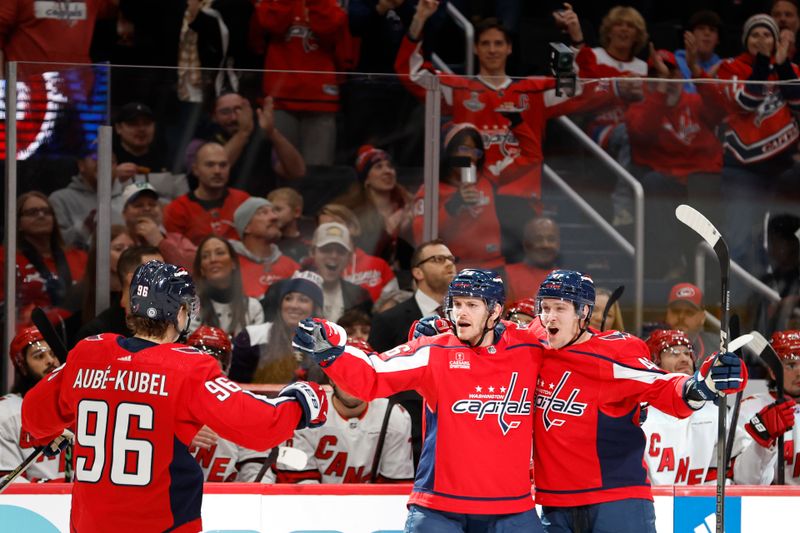 Jan 5, 2024; Washington, District of Columbia, USA; Washington Capitals right wing Nic Dowd (26) celebrates with teammates after scoring a goal against the Carolina Hurricanes in the first period at Capital One Arena. Mandatory Credit: Geoff Burke-USA TODAY Sports