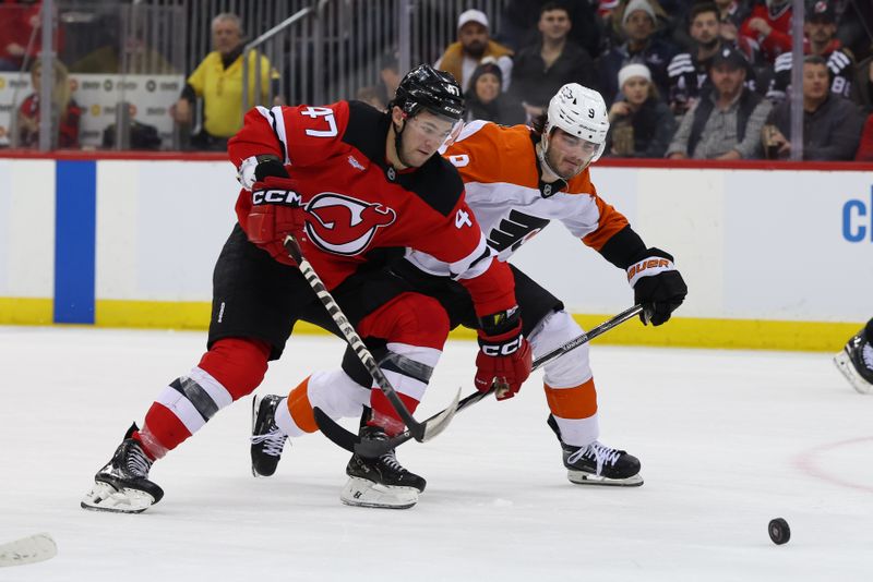 Jan 18, 2025; Newark, New Jersey, USA; New Jersey Devils center Paul Cotter (47) and Philadelphia Flyers defenseman Jamie Drysdale (9) battle for the puck during the second period at Prudential Center. Mandatory Credit: Ed Mulholland-Imagn Images