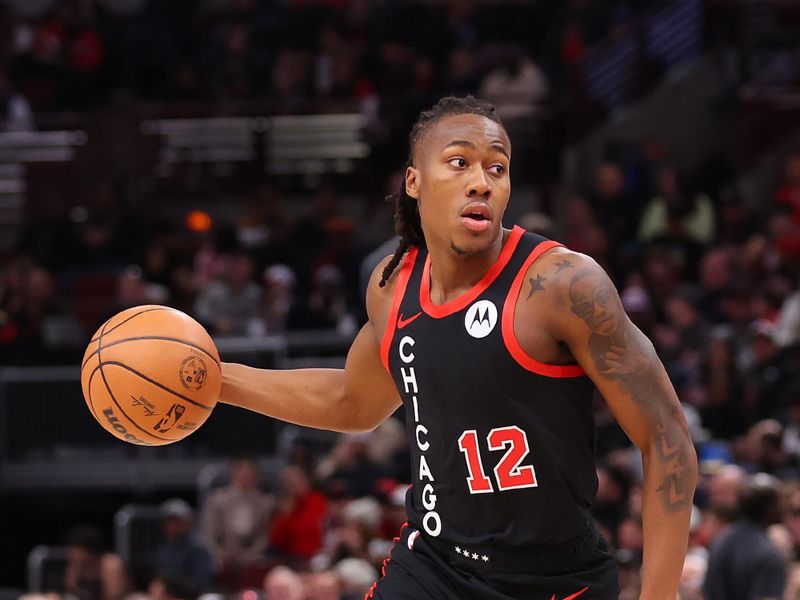 CHICAGO, ILLINOIS - JANUARY 30: Ayo Dosunmu #12 of the Chicago Bulls dribbles against the Toronto Raptors during the first half at the United Center on January 30, 2024 in Chicago, Illinois. NOTE TO USER: User expressly acknowledges and agrees that, by downloading and or using this photograph, User is consenting to the terms and conditions of the Getty Images License Agreement.  (Photo by Michael Reaves/Getty Images)