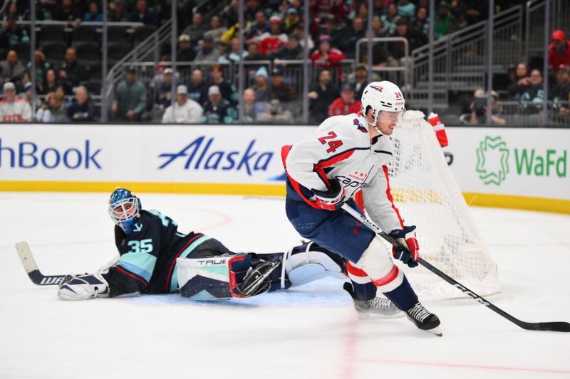 Mar 14, 2024; Seattle, Washington, USA; Washington Capitals center Connor McMichael (24) scores a goal past Seattle Kraken goaltender Joey Daccord (35) during the third period at Climate Pledge Arena. Mandatory Credit: Steven Bisig-USA TODAY Sports