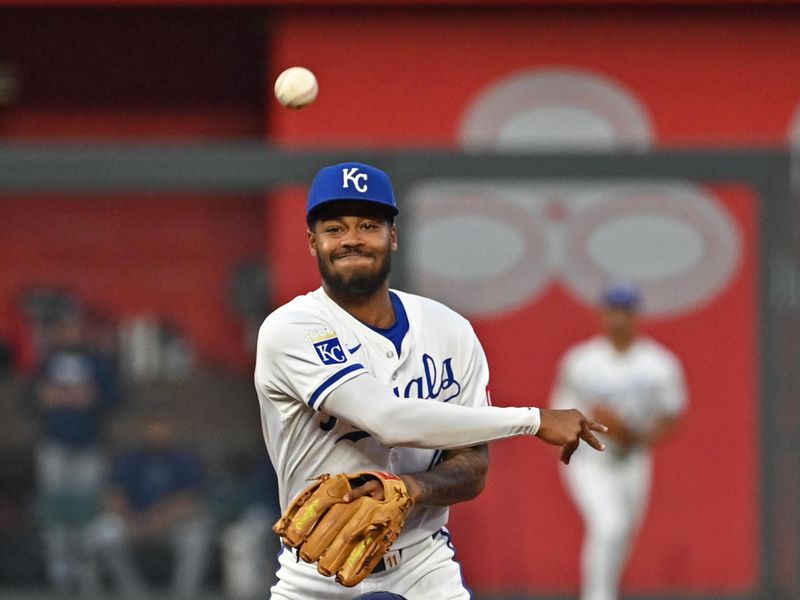 Jul 3, 2024; Kansas City, Missouri, USA;  Kansas City Royals third base Maikel Garcia (11) throws to first base after forcing out Tampa Bay Rays third baseman Amed Rosario (10) at second base in the fourth inning at Kauffman Stadium. Mandatory Credit: Peter Aiken-USA TODAY Sports