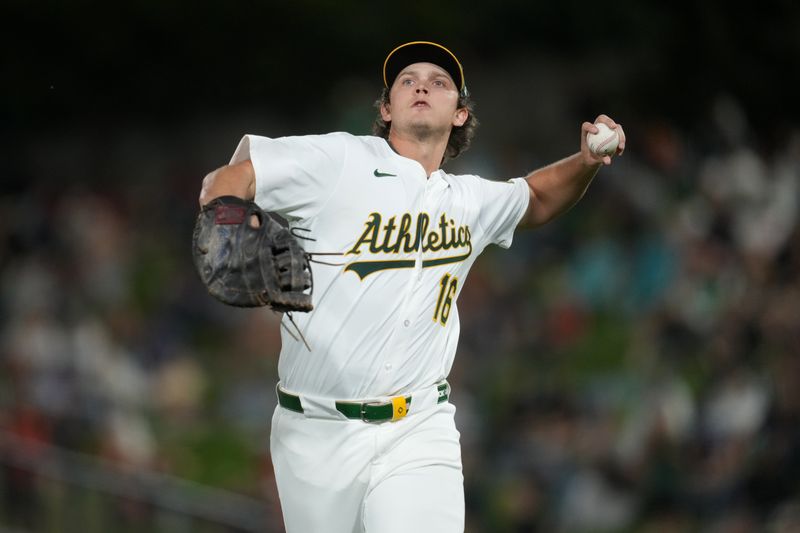 May 21, 2025; West Sacramento, California, USA; Athletics first baseman Nick Kurtz (16) tosses a ball into the crowd before the start of the seventh inning against the Los Angeles Angels at Sutter Health Park. Mandatory Credit: Cary Edmondson-Imagn Images