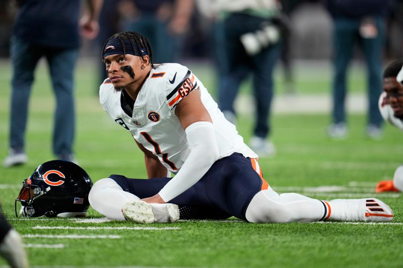 Chicago Bears quarterback Justin Fields stretches before an NFL football game against the Minnesota Vikings, Monday, Nov. 27, 2023, in Minneapolis. (AP Photo/Abbie Parr)