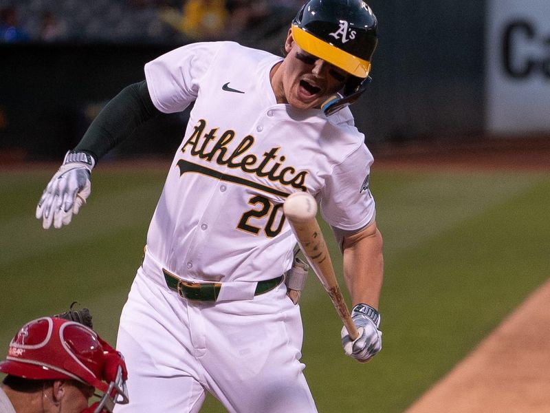 Jul 2, 2024; Oakland, California, USA; Oakland Athletics second base Zack Gelof (20) is hit by a pitch during the sixth inning of the game against the Los Angeles Angels at Oakland-Alameda County Coliseum. Mandatory Credit: Ed Szczepanski-USA TODAY Sports